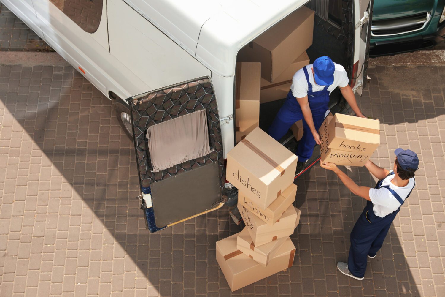 Movers Unloading Boxes From Van Outdoors Movers Unloading Boxes From Van Outdoors