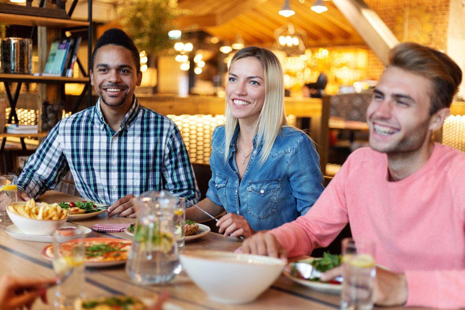 Smiling friends talking at dinner party