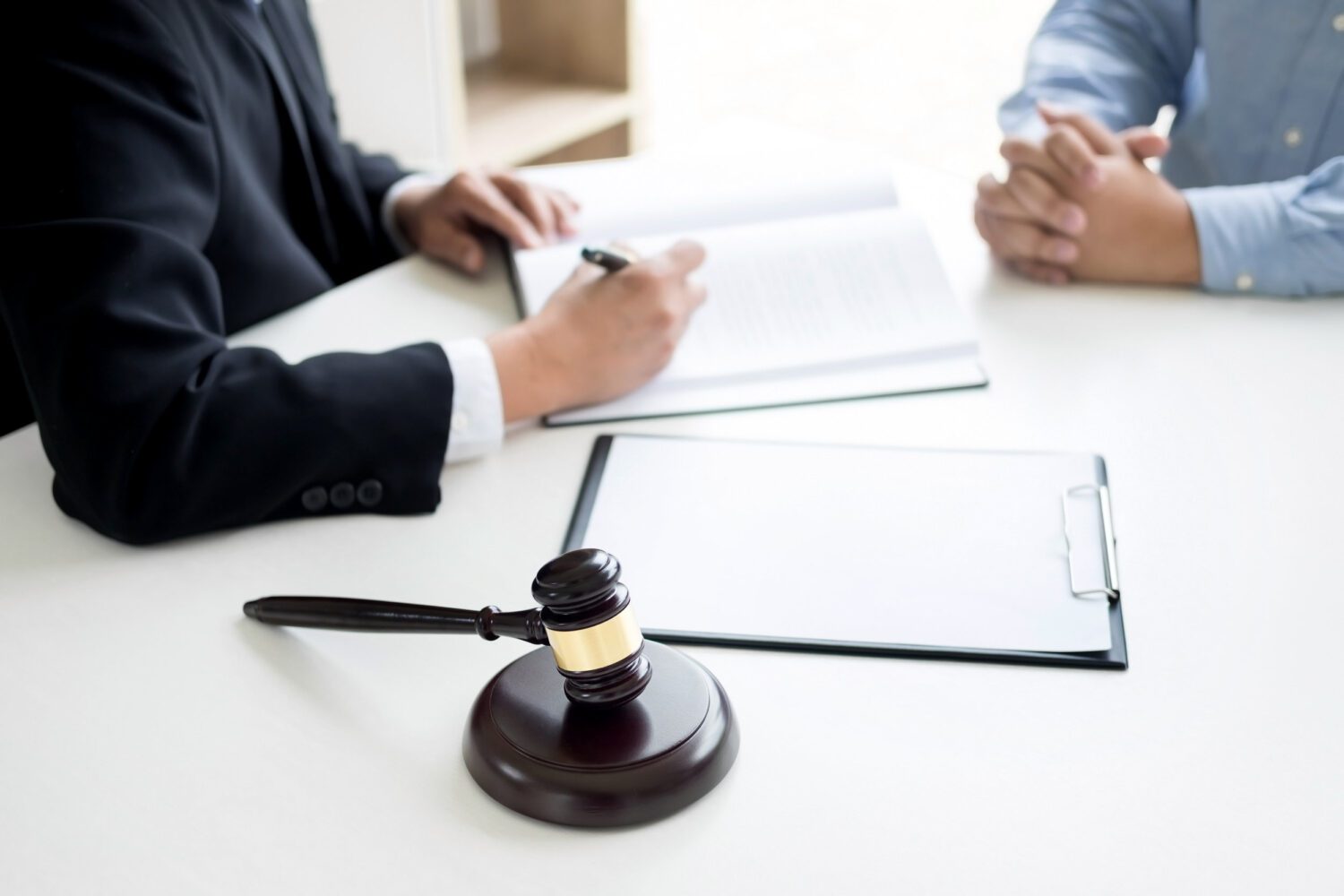 Judge Gavel With Lawyers Advice Legal At Law Firm In Background. Judge Gavel With Lawyers Advice Legal At Law Firm In Background.